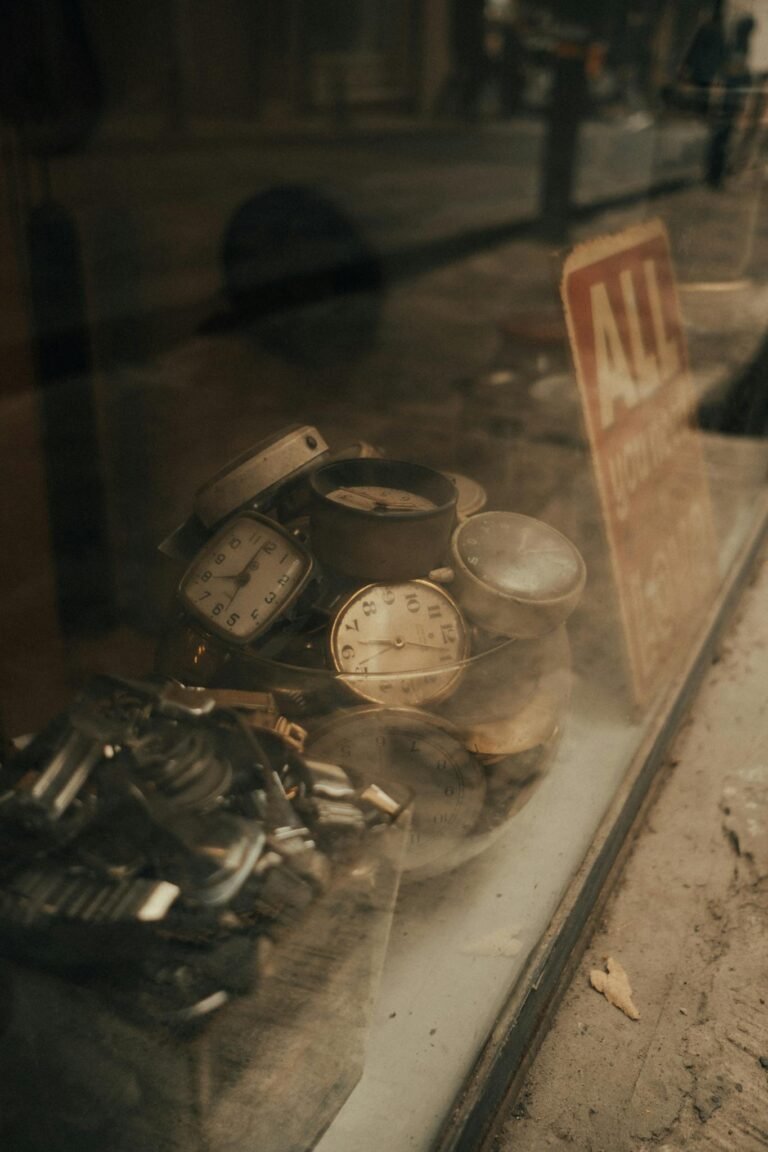 Discover a collection of vintage watches in an antique store window, evoking a retro feel.